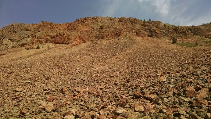 Brightly multicolored rocks on the steep slopes of an unnamed ridge in the San Juan Mountains