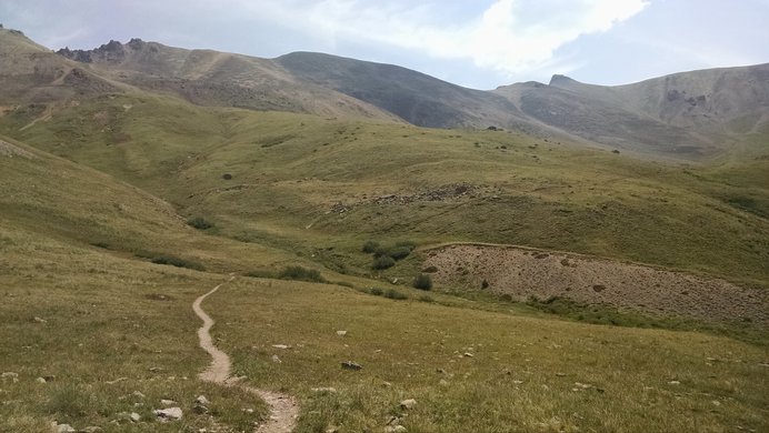 The trail to Redcloud Peak dipping lower and turning south to approach Redcloud Peak's saddle