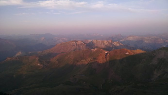 Alpenglow touches the lower peaks near Wetterhorn Peak