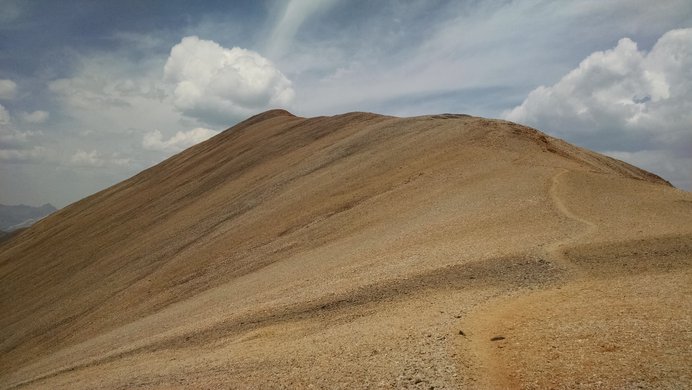 The stripes of yellow-orange rocks on Redcloud Peak's west ridge