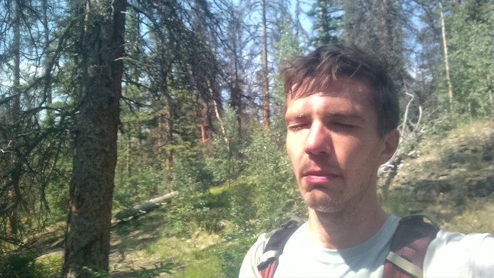 A sweaty hiker grimacing on the trail to Redcloud and Sunshine Peak